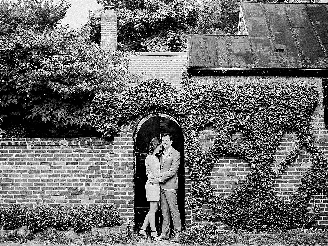 Spring Old Town Alexandria Engagement Session against ivy-filled brick wall