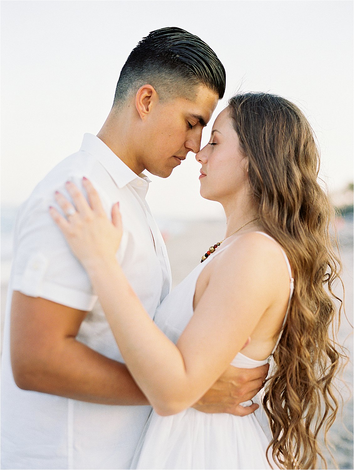 Intimate moment between newly engaged couple in Palm Beach, Florida with film wedding photographer, Renee Hollingshead