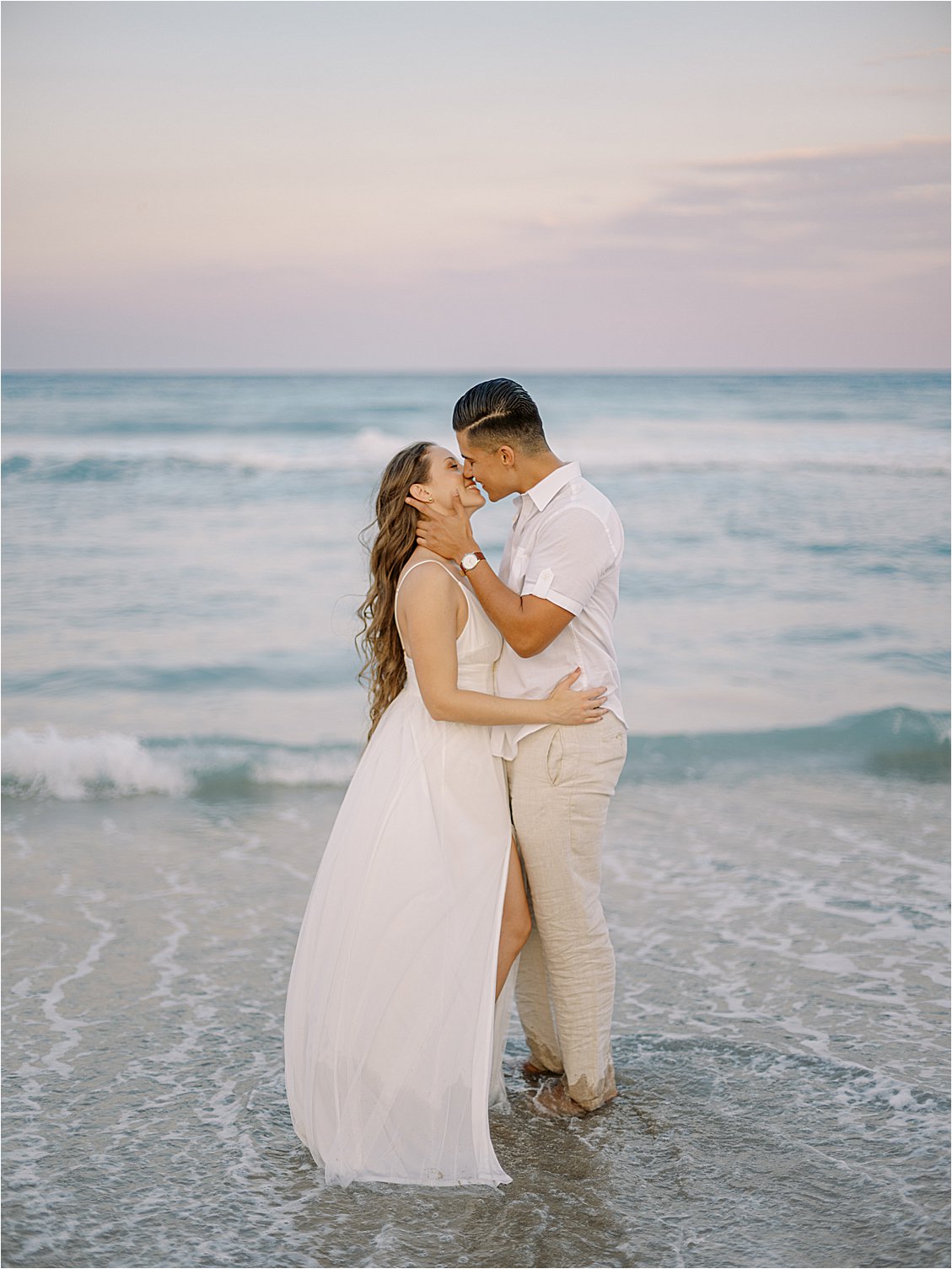 Couple kisses at shoreline with Destination Film Wedding Photographer, Renee Hollingshead