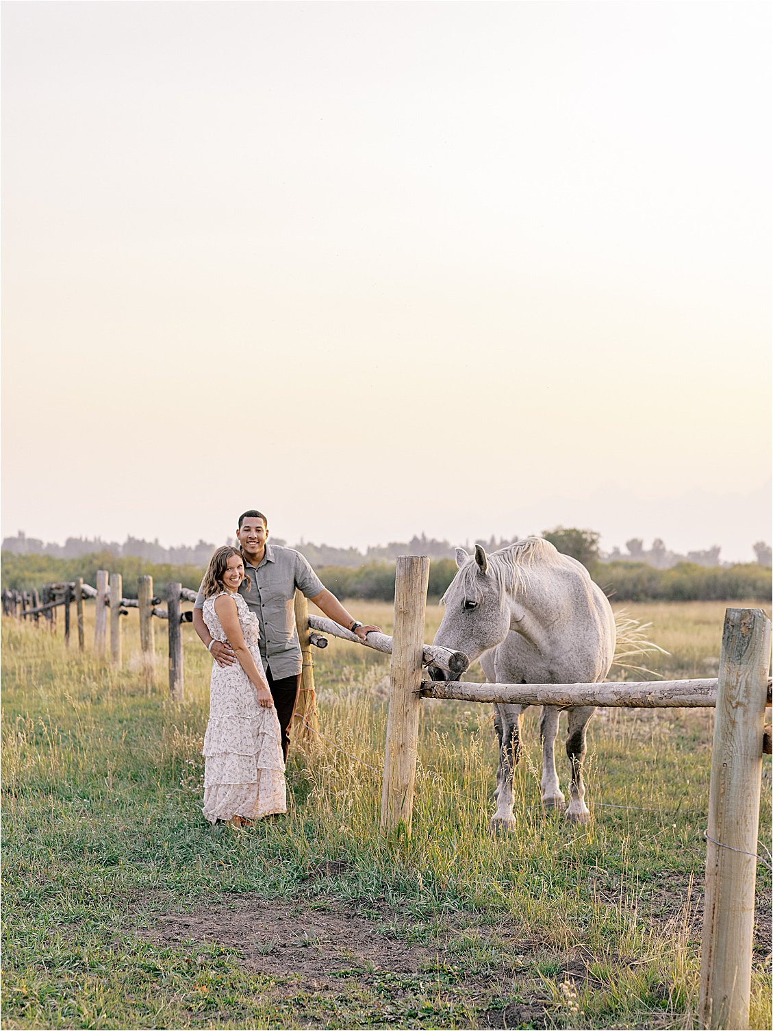 Couple with white horse in Wyoming photographed by film wedding photographer Renee Hollingshead