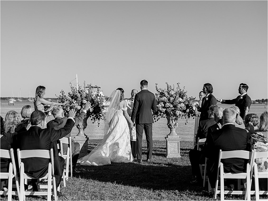 Black and white image of waterfront wedding ceremony in St. Michaels, Maryland