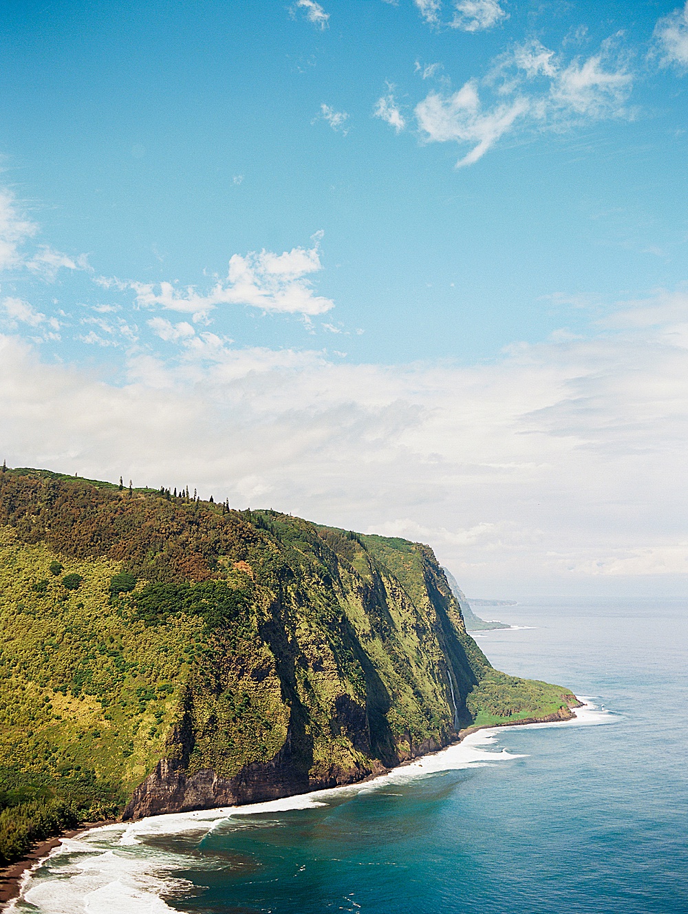 View from Lookout at Waipio Valley Black Sand Beach with destination film wedding photographer, Renee Hollingshead