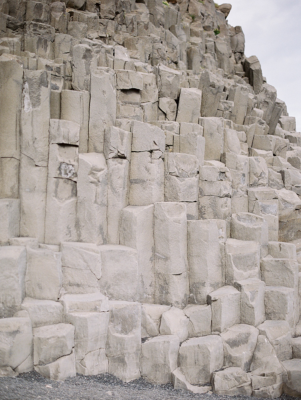 Reynisfjara basalt columns at Vik Black Sand Beach on film by destination film wedding photographer Renee Hollingshead