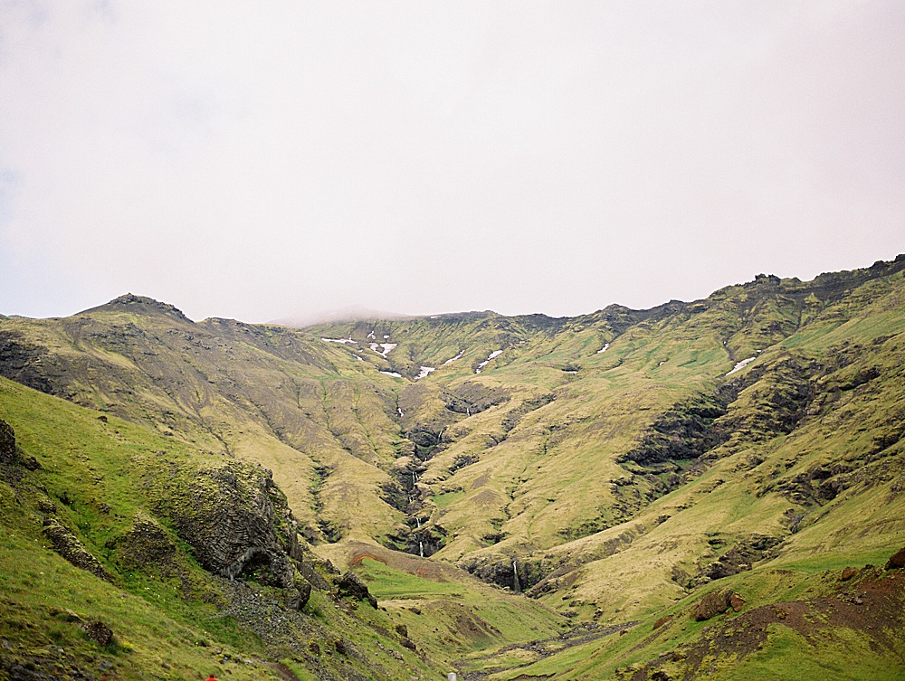 Film image of mountains near Seljavallalaug outdoor swimming pool in Iceland by destination wedding photographer Renee Hollingshead