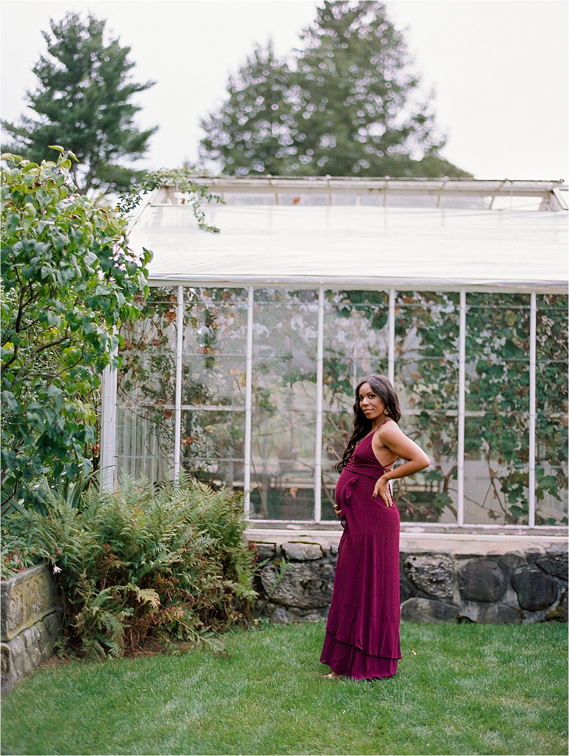Mom to be in burgundy dress at Garden Maternity session at Stevens-Coolidge House with destination film photographer Renee Hollingshead