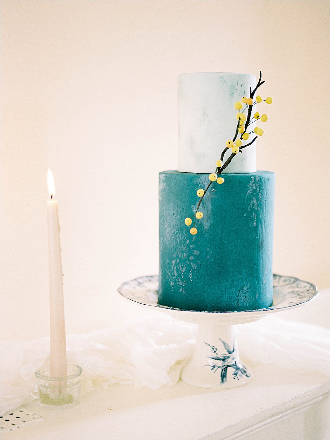 Hand stenciled two tier two-toned wedding cake with sugar yellow berries photographed by DC film wedding photographer Renee Hollingshead