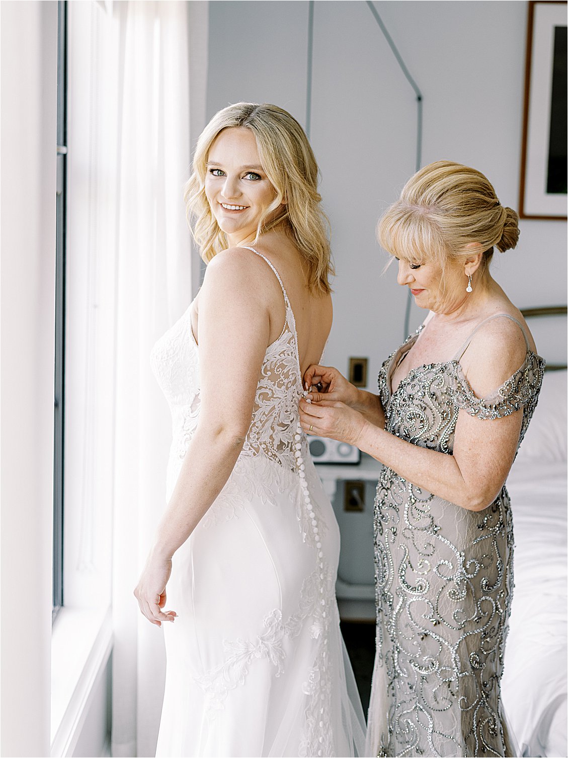 Bride getting ready for her wedding day in a lace Essense of Australia gown