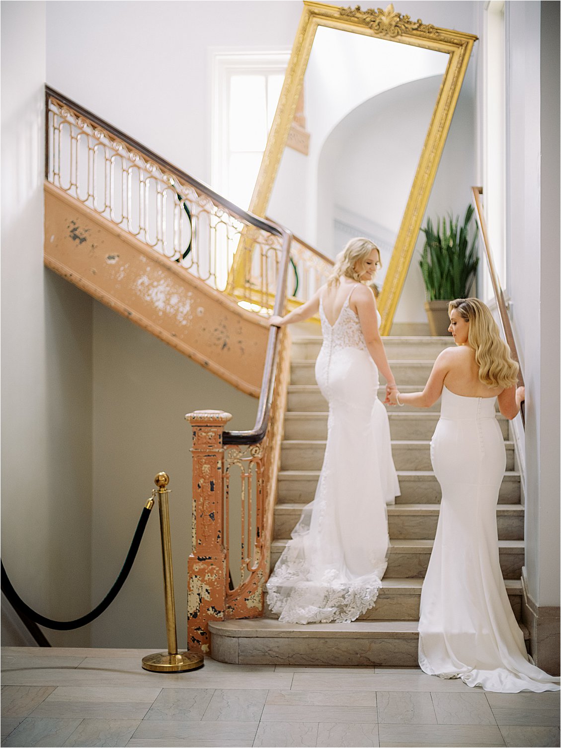 Brides walking up iconic DC Line Hotel staircase after first look