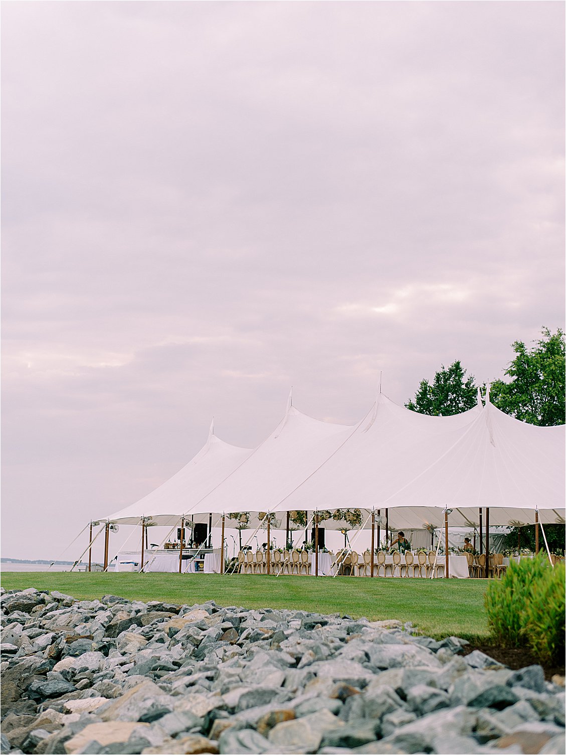 Sailcloth reception tent set along the Chesapeake Bay waterfront for an elegant private estate wedding on Maryland’s Eastern Shore.