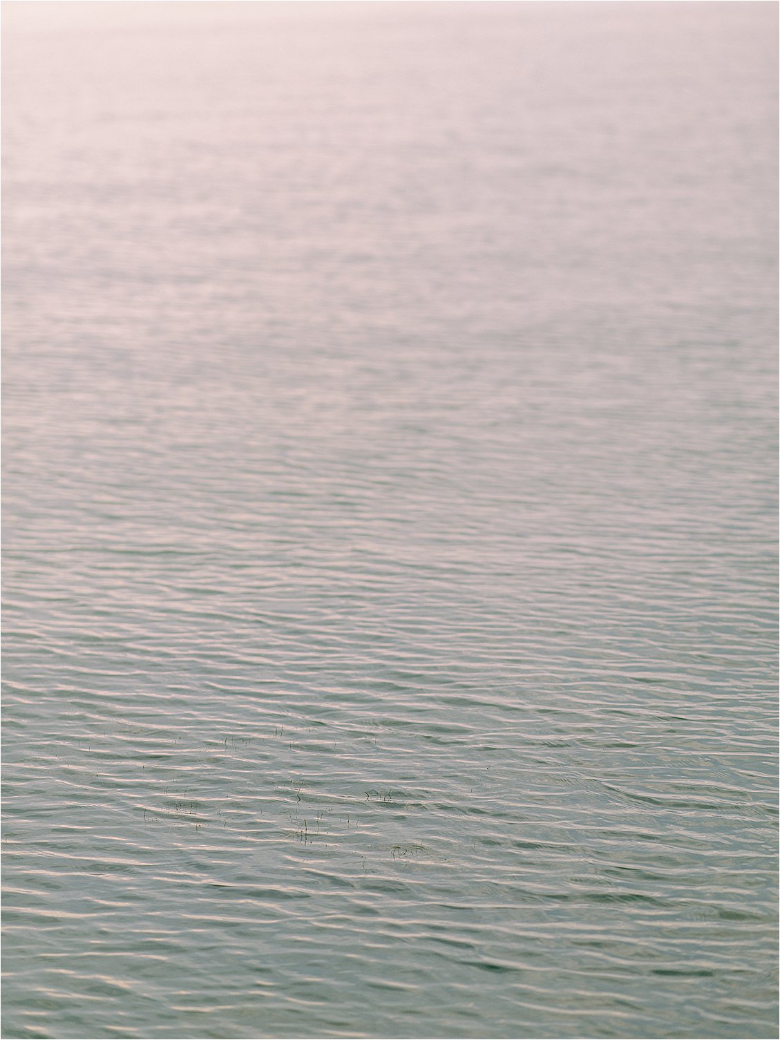 Soft pastel sunset over the Chesapeake Bay waterfront at an elegant Eastern Shore private estate wedding in Maryland.