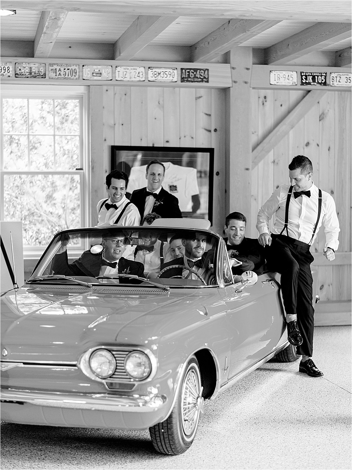 Groom and groomsmen celebrating in a vintage convertible during preparations at an Eastern Shore waterfront estate wedding.