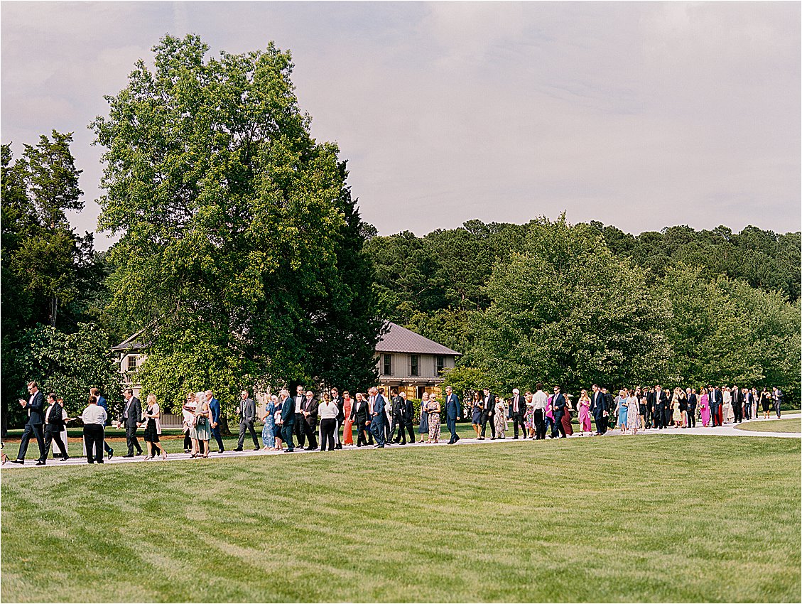 Wedding guests arriving and walking the lawn at private estate wedding on Maryland’s Eastern Shore