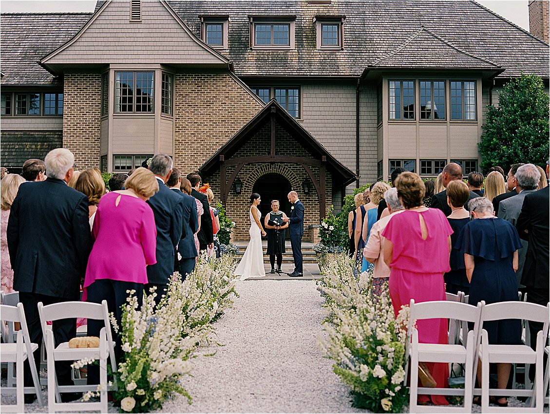 Outdoor wedding ceremony in front of private waterfront estate home on Maryland’s Eastern Shore