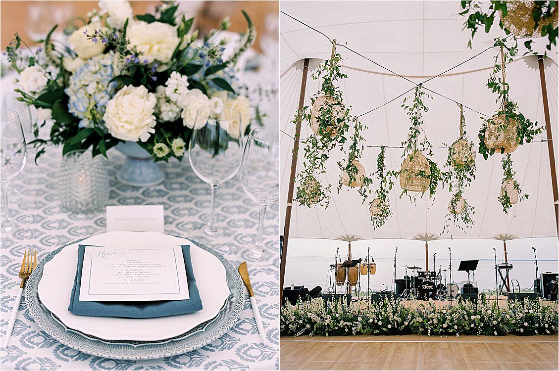 Blue and white wedding place setting with menu card and floral centerpiece at Eastern Shore waterfront reception. Hanging woven lanterns and greenery installation above band stage inside sailcloth wedding tent.