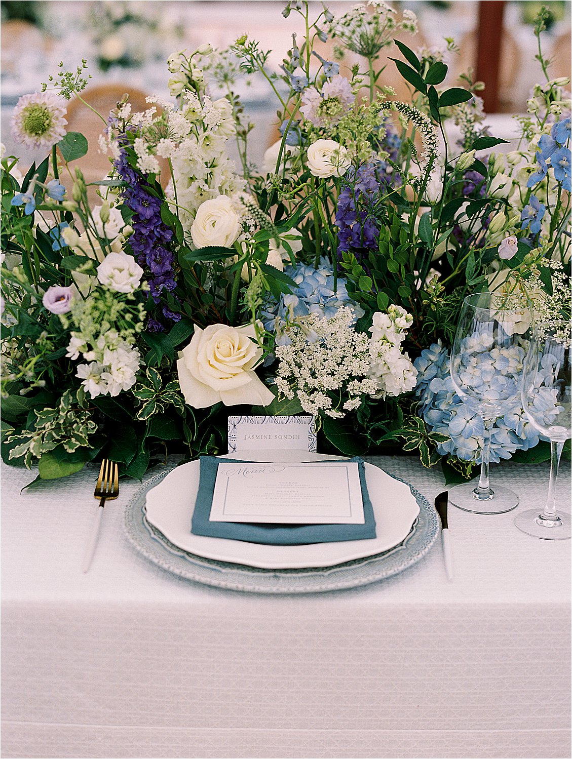 Blue and white wedding floral centerpiece with hydrangeas and garden flowers at Eastern Shore estate reception