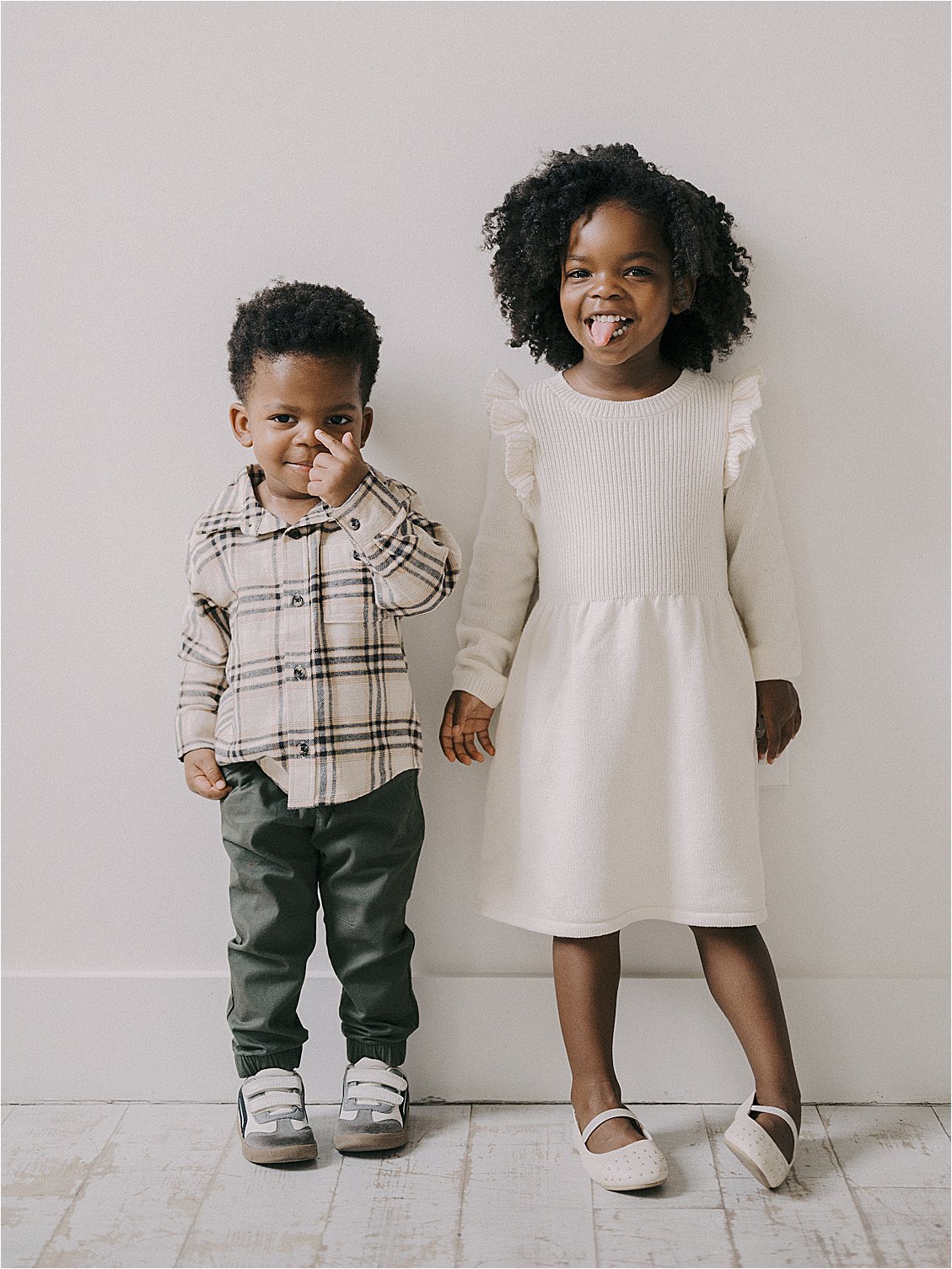 Young boy and girl siblings making silly faces together in studio — boy picking his nose, girl sticking out tongue — candid sibling portrait, film family session Annapolis Maryland by Renee Hollingshead Photography
