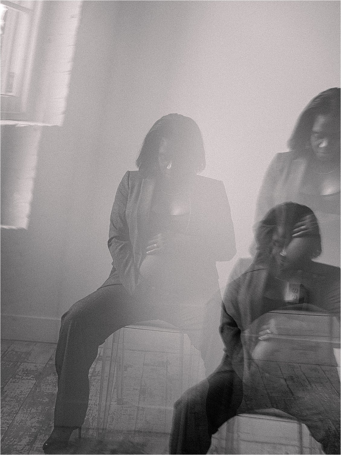 Black and white film double exposure of expecting mother in blazer seated in studio, dreamy layered effect, studio maternity session Annapolis Maryland by Renee Hollingshead Photography
