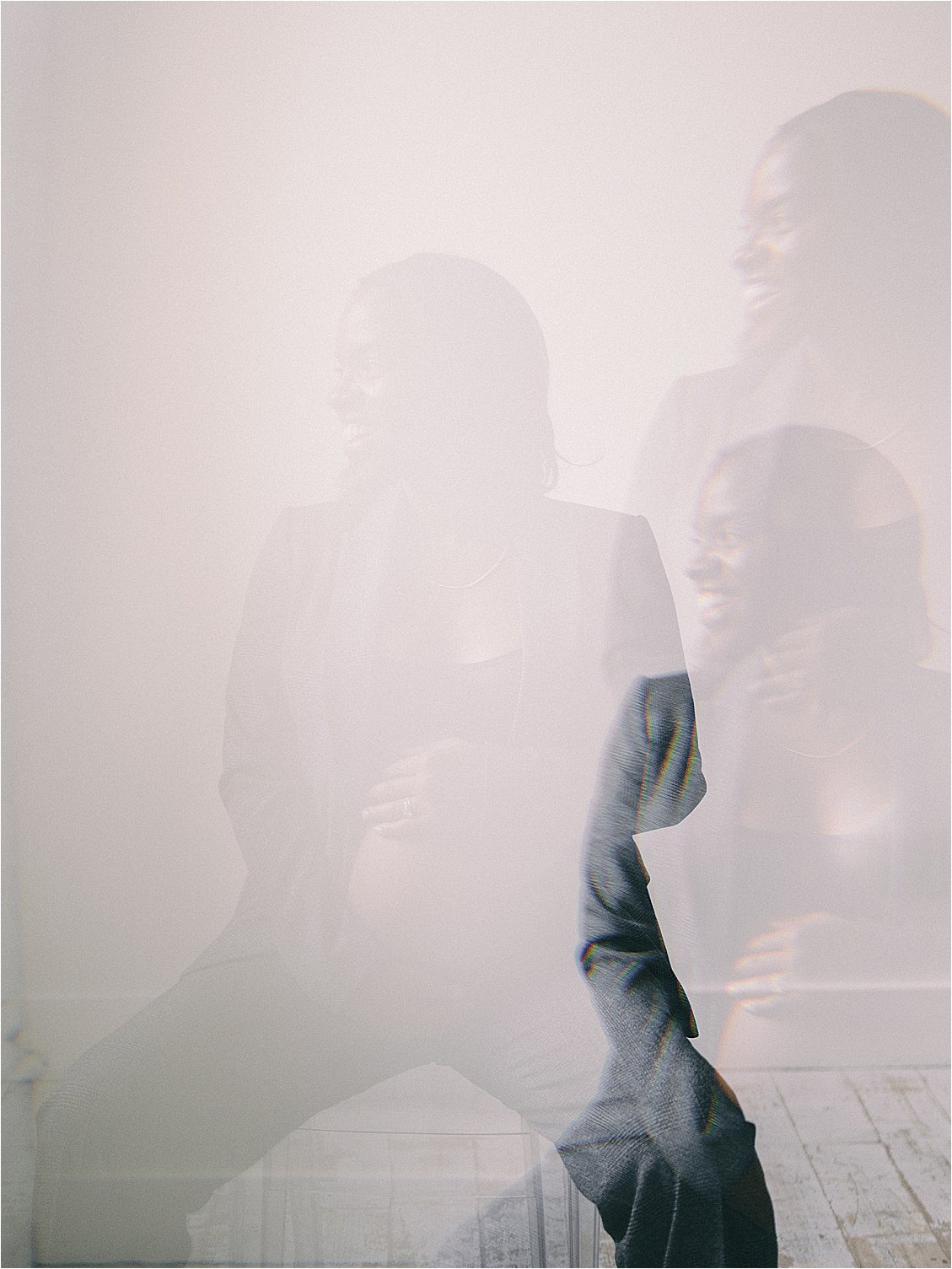 Ethereal color film double exposure of expecting mother in blazer cradling baby bump, studio maternity session Annapolis Maryland by Renee Hollingshead Photography