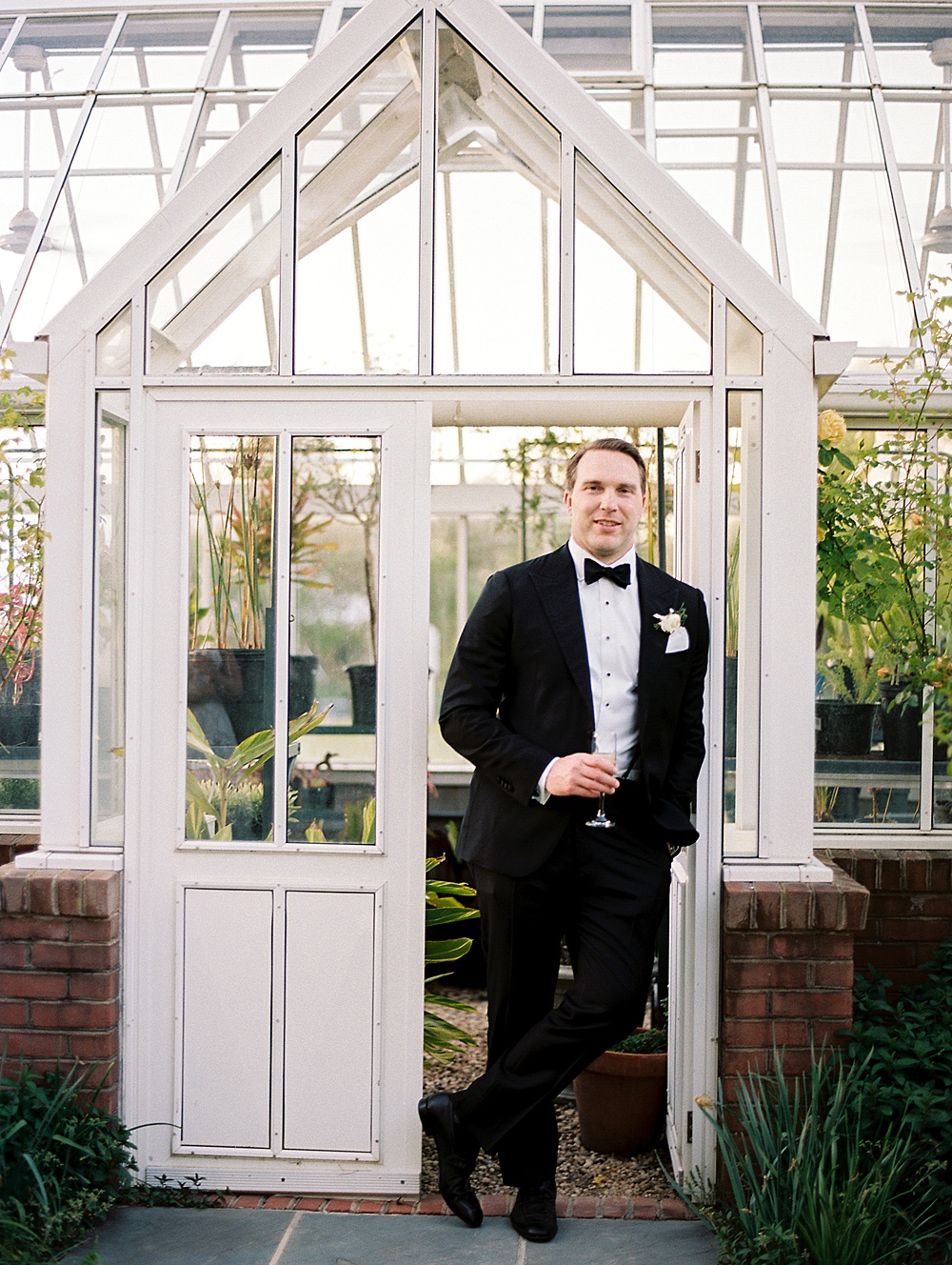 Groom portrait in the greenhouse at Inn at Perry Cabin wedding, captured on film by Renee Hollingshead Photography